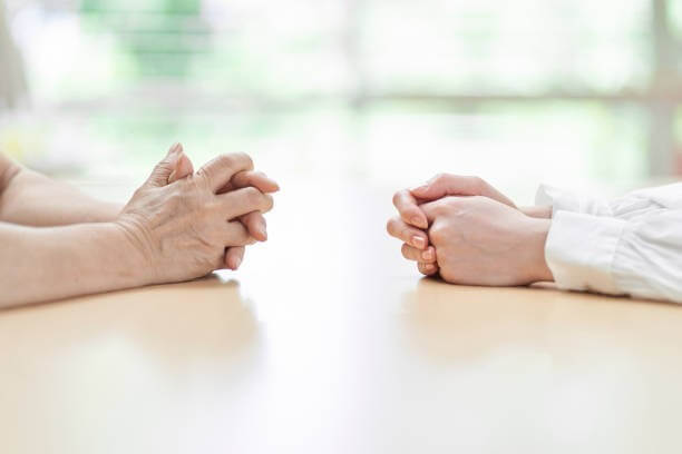 Two people sitting across from each other.